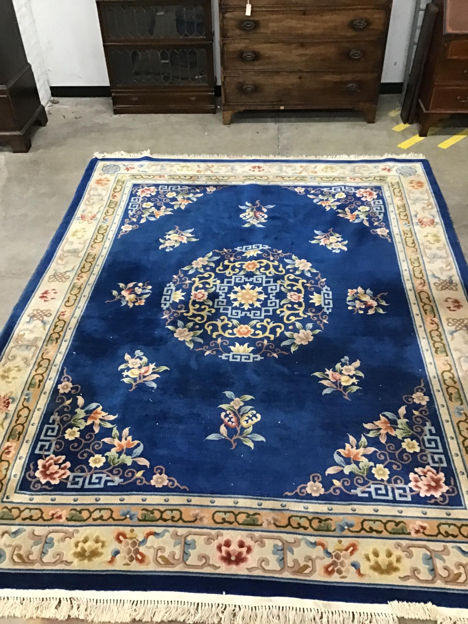 A Chinese blue ground carpet with floral field, 315 x 245cm